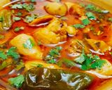 A picture of step 7 of Arvi Gosht with chapati.