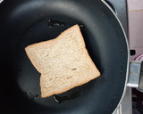 A picture of step 2 of Beans on scrambled egg on toast.