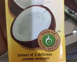 A picture of step 4 of Coconut Mawa balls immersed in Creamy Coconut saffron milk.