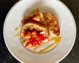 A picture of step 3 of Eggy bread with strawberries and maple syrup.