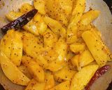 A picture of step 8 of Kumaoni Aloo Gutke with pooris.