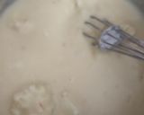 A picture of step 4 of Eggless mawa cup cake topping with shrikhand.