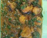 A picture of step 3 of Prawn curry with spring onion.