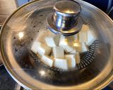 A picture of step 5 of Steamed tofu with sweet soy dressing sauce and spring onions.