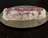 A picture of step 26 of Patriotic Vanilla Cake Roll with Whipped White Chocolate Ganache Filling and Frosting.