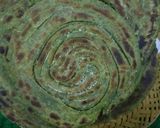 A picture of step 3 of Hariyala laccha paratha (layered green flat bread).