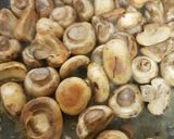 A picture of step 2 of Buttered Mushrooms in a little white wine and Balsamic Vinegar.