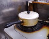 A picture of step 4 of Boiled white rice, used a pot with lid.