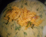A picture of step 3 of Spinach kathi roll in fishbone wrap with red souce pasta.