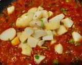 A picture of step 4 of Shakshuka (In my style- Poached eggs in tomato and veggie gravy).