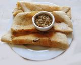 A picture of step 3 of LUNCH IS SERVED: Little millet dosai with onion sambar, curry leaf chutney and mung sprouts.