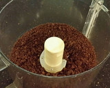 A picture of step 12 of Chocolate Layer Cake with Strawberry Cream Filling, White Chocolate Ganache Frosting coated with a Chocolate Crumble.