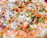 A picture of step 7 of Chicken Tikka pizza.