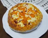 A picture of step 6 of Pizza covered with homemade Mozzarella Cheese & Sausage.