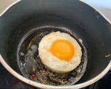 A picture of step 5 of Corn cake with bacon and sriracha mayo sunny side up.