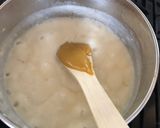 A picture of step 8 of Anti Vampire Cheese Sauce, with Onions and Garlic.