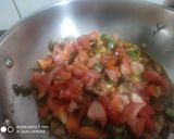 A picture of step 3 of Shakshuka with warm garlic bread (poached eggs in spicy sauces).