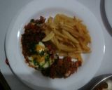 A picture of step 11 of Shakshuka accompanied by French fries.