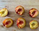 A picture of step 1 of Baked Peaches with Amaretti, Dark Chocolate, Ice Cream and Mint.