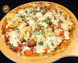 A picture of step 10 of Cheese Burst Veggies And Chicken Pizza From Scratch.