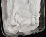 A picture of step 4 of Tiramisu with whipping cream.