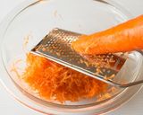 A picture of step 2 of Carrot Rape with Raisins.