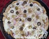 A picture of step 2 of Tawa Veg Pizza with Olives.