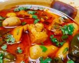 A picture of step 7 of Arvi Gosht with chapati.
