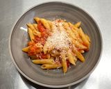 A picture of step 9 of Penne al'arrabiata (pasta with a spicy tomato sauce).