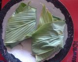 A picture of step 6 of Pomfret fry wrapped in turmeric leaves.