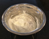 A picture of step 5 of Vanilla Layer Cake filled withLenon and Rasberry and frosted with Fresh Lemon Cream.