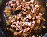 A picture of step 7 of Paella with Secreto Pork, Mushrooms, and Green Garlic.