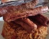 A picture of step 3 of Jollof rice with sausage.