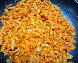 A picture of step 6 of Cheesey spiral Pasta in red sauce.