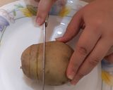 A picture of step 2 of Hasselback Potatoes.
