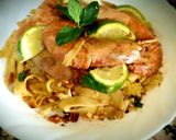 A picture of step 4 of Pad thai with king prawns and lemon slices and tagliatelle rice.