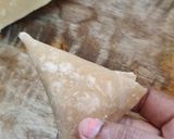 A picture of step 12 of Poha onion triangle samosa.