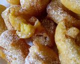 A picture of step 3 of Sweet Banana fritters with dusting of icing sugar n cinnamon.