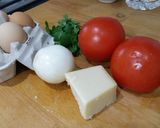 A picture of step 1 of Herby cheese, egg and tomato scramble.