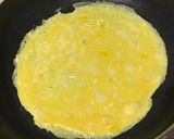 A picture of step 11 of Fluffy One-Egg Butter Rice Omurice.