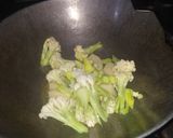 A picture of step 3 of Cauliflower curry with white gravy.