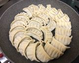 A picture of step 10 of Juicy Pan-Fried Dumplings with Napa Cabbage and Garlic Chives.
