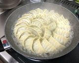 A picture of step 11 of Juicy Pan-Fried Dumplings with Napa Cabbage and Garlic Chives.