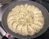 A picture of step 12 of Juicy Pan-Fried Dumplings with Napa Cabbage and Garlic Chives.