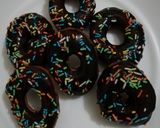 A picture of step 9 of Cardamon donuts with chocolate glaze.