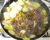 A picture of step 13 of Beef and Tofu Sukiyaki-Style with Napa Cabbage and Scallions.