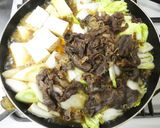 A picture of step 11 of Beef and Tofu Sukiyaki-Style with Napa Cabbage and Scallions.