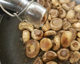 A picture of step 2 of Buttered Mushrooms in a little white wine and Balsamic Vinegar.