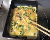 A picture of step 2 of Tamagoyaki with Pickled Ginger and Scallions.