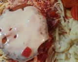 A picture of step 4 of Swiss on Chicken atop Linguine.